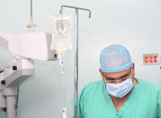 Surgeon testing the infusion to a patient