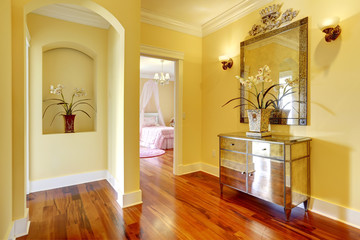 Bright hallway with shiny cabinet and flowers