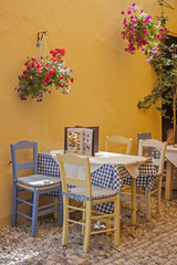 Fototapeta na wymiar a typical Greek taverna with tables and straw chairs