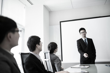 businessman giving a presentation to his colleagues
