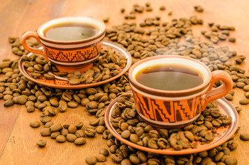 Coffee on a wooden table with coffee grains