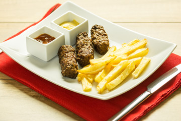 Traditional Romanian Mici And Fries With Ketchup And Mustard