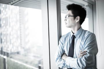 Fototapeta premium Portrait of a businessman looking at the window