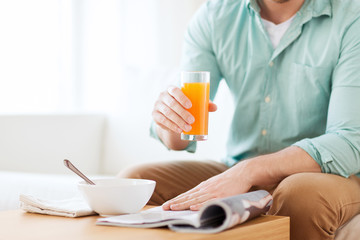 close up of man with magazine drinking juice