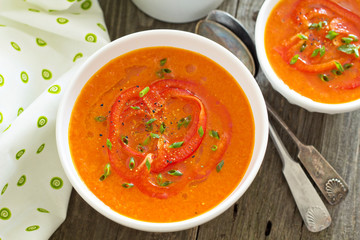 Roasted red peper soup in white bowl