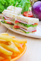 Club Sandwich with Cheese, Pickled Cucumber, Tomato and ham. Gar