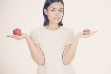 Smiling woman with apple isolated on white