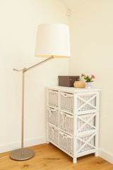 Commode and lamp in bright room