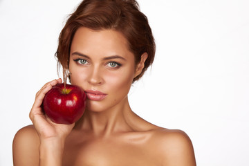 Young sexy girl holding big red apple to enjoy the taste