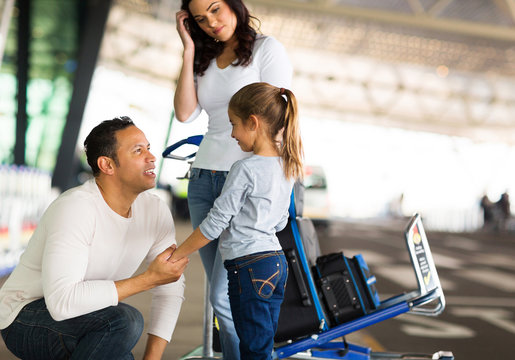 man talking to her daughter at airport before departure