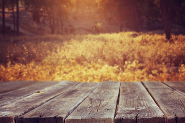 Naklejka na ściany i meble Wood board table in front of summer landscape with lens flare