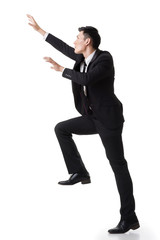 Asian businessman climbing