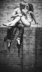 Middle Age Romantic Couple Kissing Above Wall
