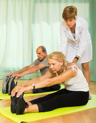 Medical staff with senior people at gym