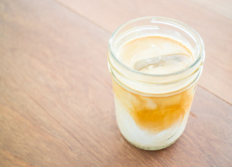 Cold coffee latte with ice in glass