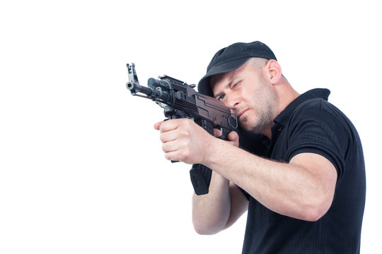 Man pointing AK-47 machine gun, isolated. Focus on the gun