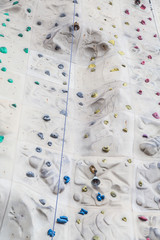Ropes Footholds and Bells on Rock Climbing Wall