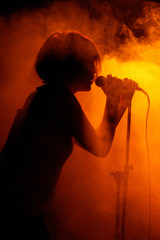 Concert photo of female singer holding microphone