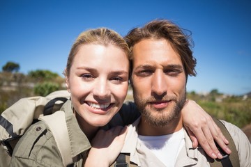 Happy hiking couple on mountain terrain