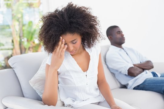 Attractive couple having an argument on couch