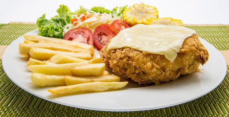 Pork chop Cordon bleu, with French fries and vegetables garnish