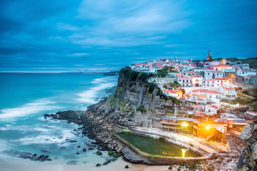 Fototapeta premium Azenhas do Mar village at dusk with stormy sea and dark clouds,