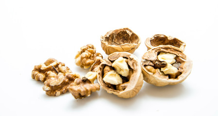 walnut and a cracked walnut on the white background