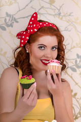 pinup redhead girl with colorful cupcakes.