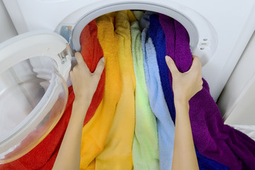 woman taking color  clothes from washing machine
