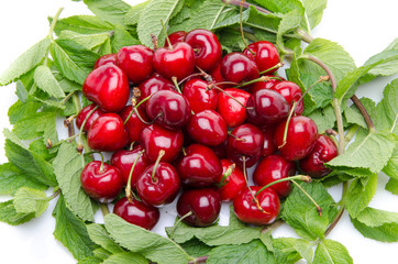 Composition with red cherries surrounded with mint