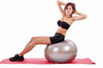 Fototapeta na wymiar Beautiful healthy young girl with a fitness ball 