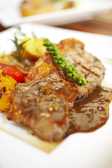 close up beef ribs steak and sauce in white dish