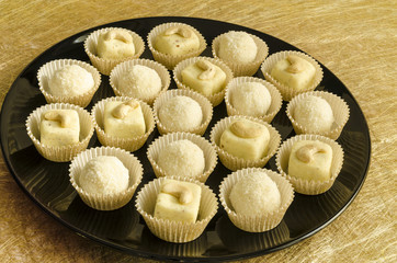 White chocolate homemade truffles on black plate