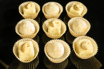 White chocolate homemade truffles on black background
