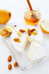 cheese, nuts and honey on the board
