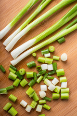 Spring green onion on wooden board