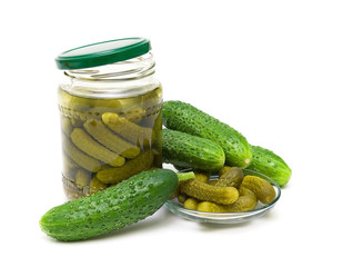 fresh and pickled cucumbers on white background