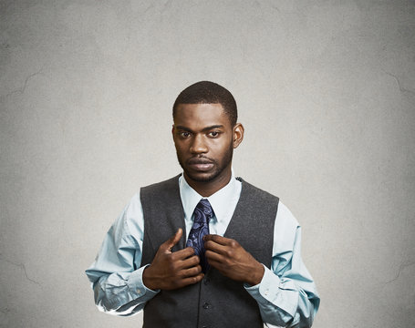 Portrait Shy, socially awkward business man, grey background 