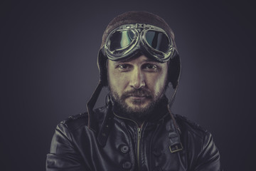 war pilot dressed in vintage style leather cap and goggles