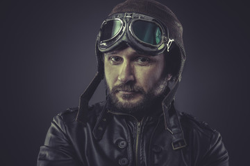 steampunk pilot dressed in vintage style leather cap and goggles