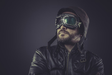 motivation pilot dressed in vintage style leather cap and goggle