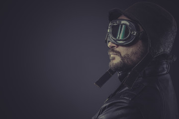 portrait pilot dressed in vintage style leather cap and goggles - obrazy, fototapety, plakaty