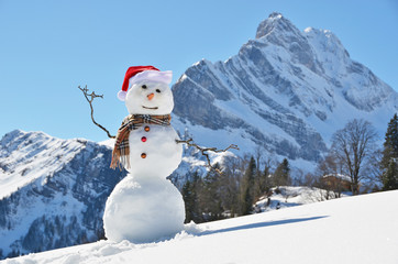 Snowman against Alpine panorama