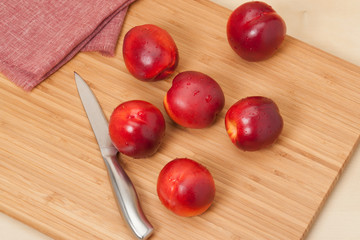 Fresh Nectarine Fruits On Wooden Board. Natural Linen Napkin