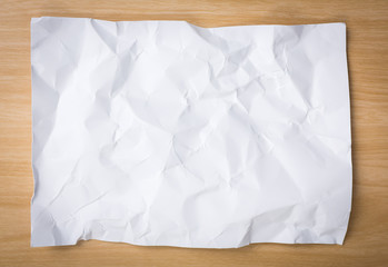 Obraz premium White crumpled pencil on a wooden desk