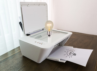 Fototapeta premium Printer with Bulb for idea on paper