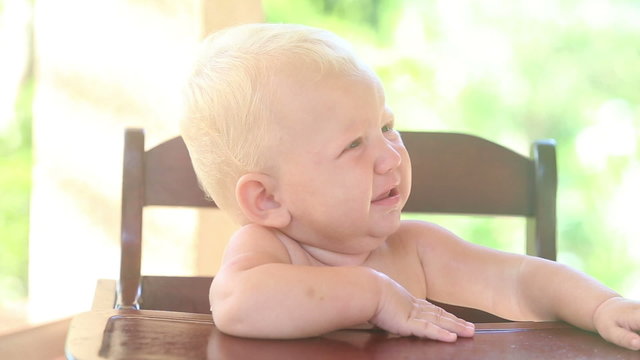 baby eat bread on chear