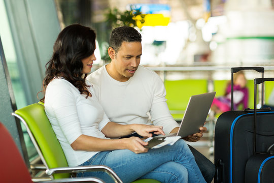 couple using laptop computer at airport