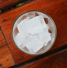 Water glass with ice cubes