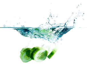 sliced cucumber splashing water isolated on white background